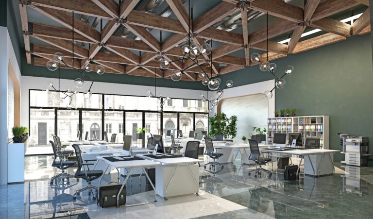 Um escritório amplo com várias mesas e impressora laser.